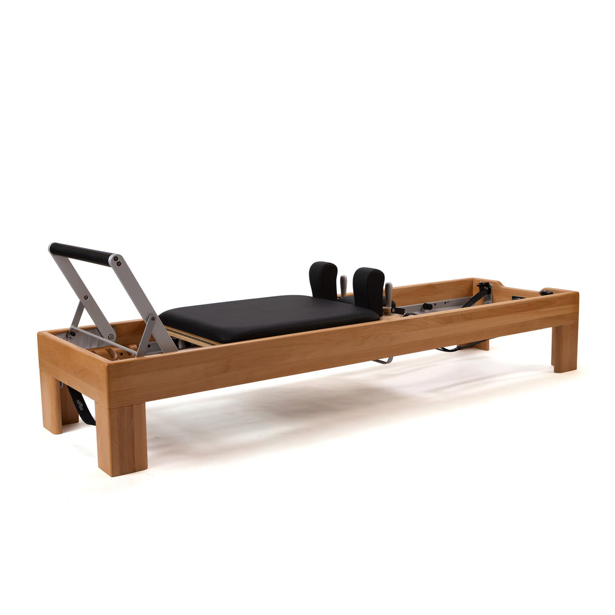 Wood-frame Pilates reformer in a studio setting