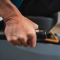 Hand holding the LXT-700 seat-side contact pulse grip.