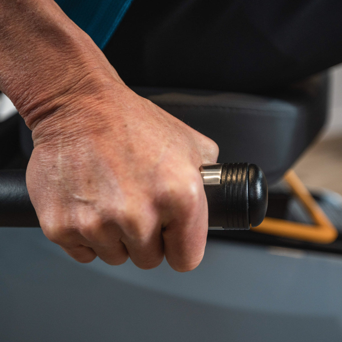 Hand holding the LXT-700 seat-side contact pulse grip.