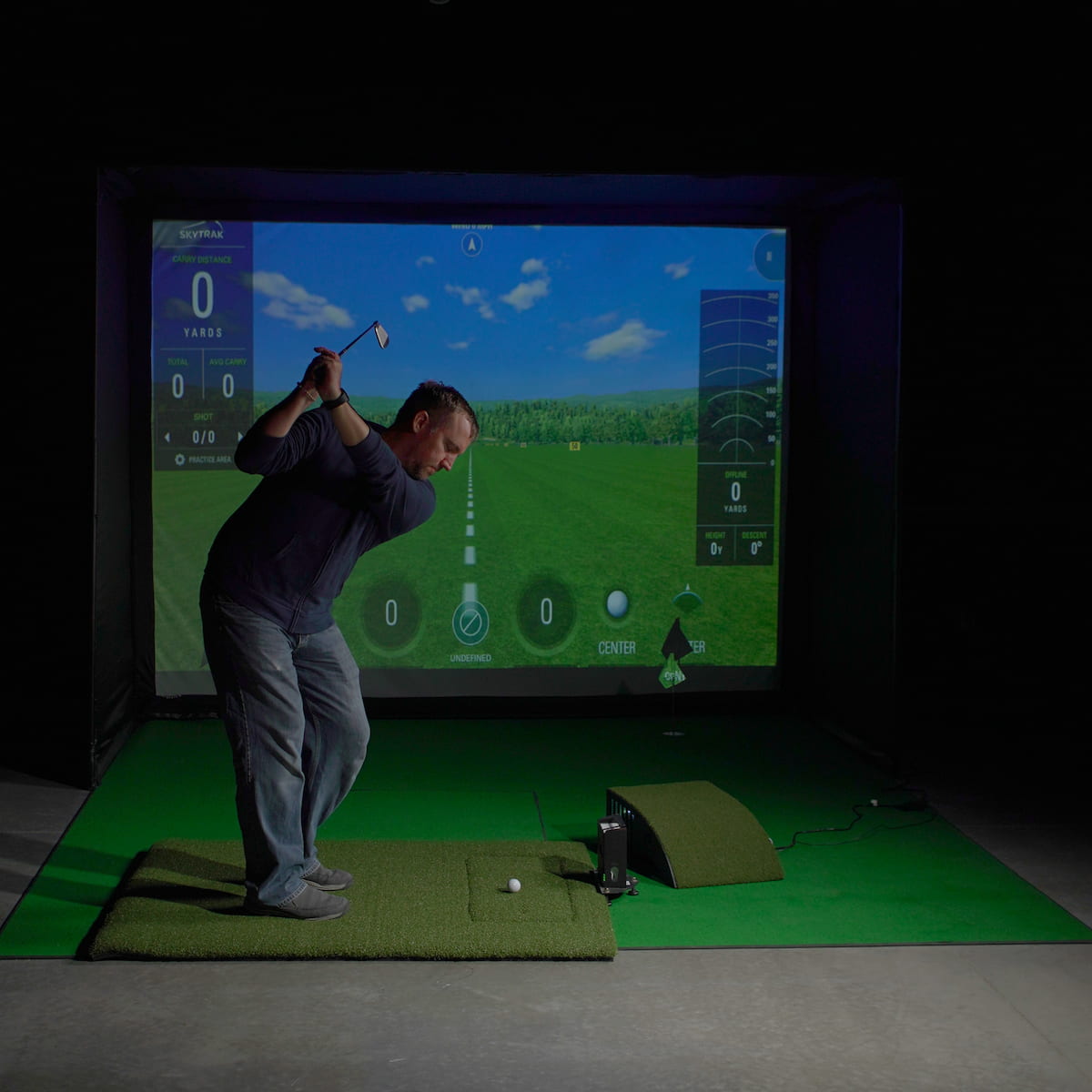 Iron addressing a golf ball on the HotShot hitting surface