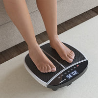 Close-up of bare feet resting on a VibraPro Reflexology M1 vibration platform